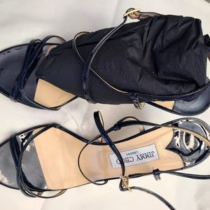 Jimmy Choo black cross front patent leather shoes.  Heel 4 inches